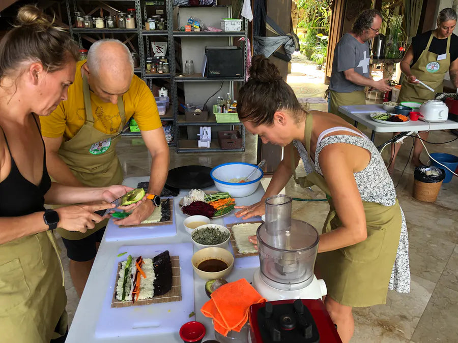 Students preparing nori rolls together during class