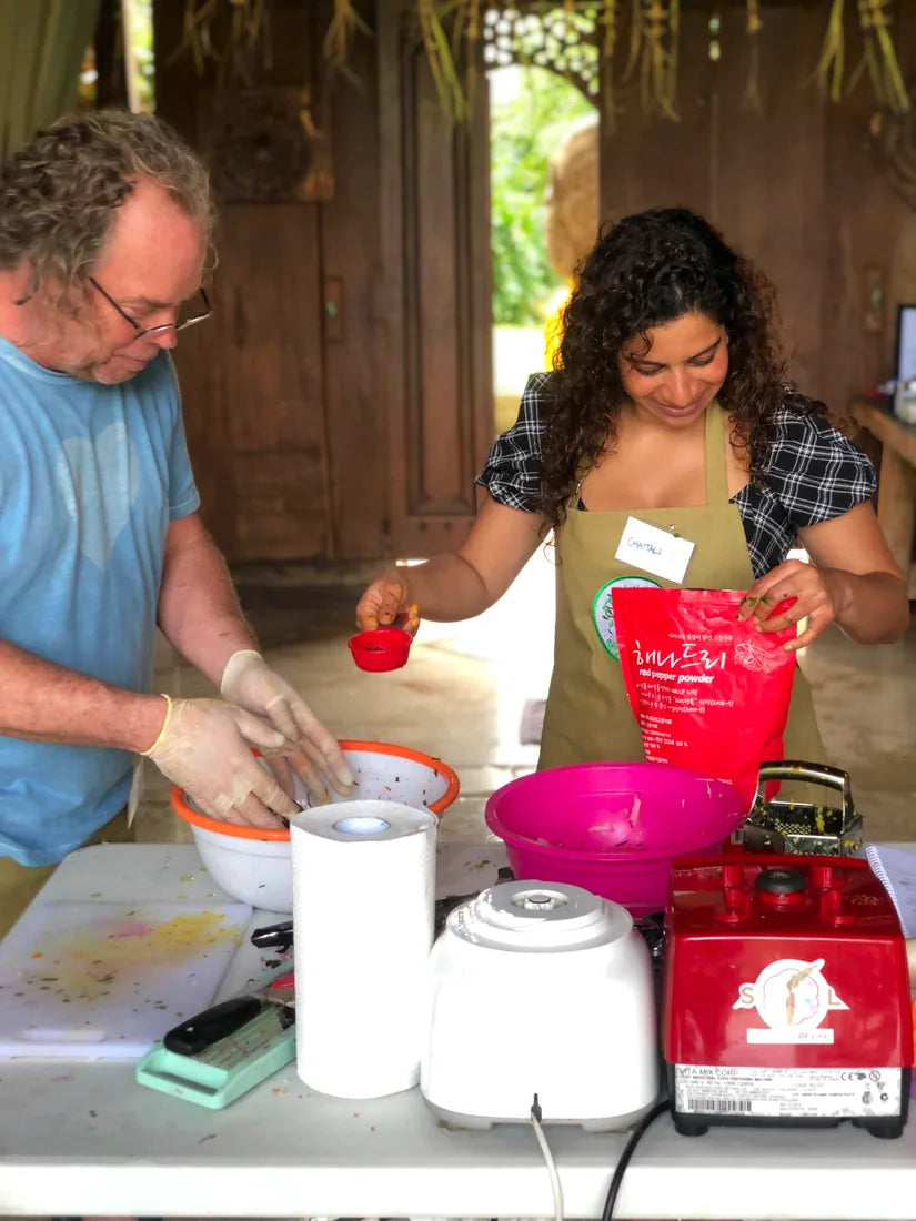 Students seasoning a dish together during class