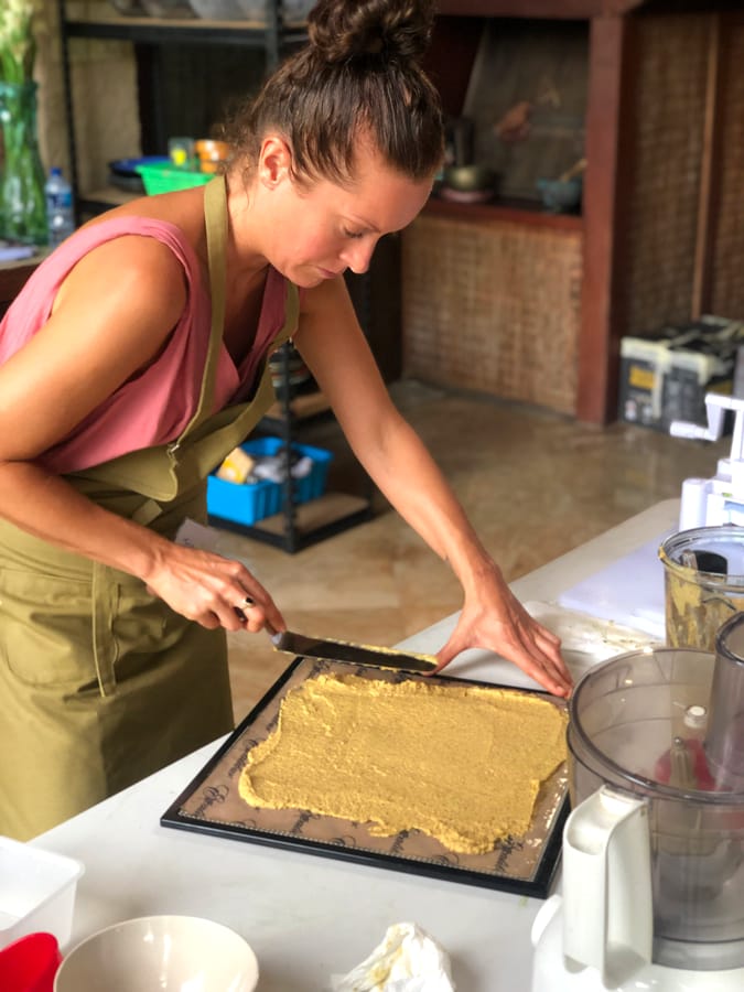 A student concentrating as she spreads a dehydrator mixture during class